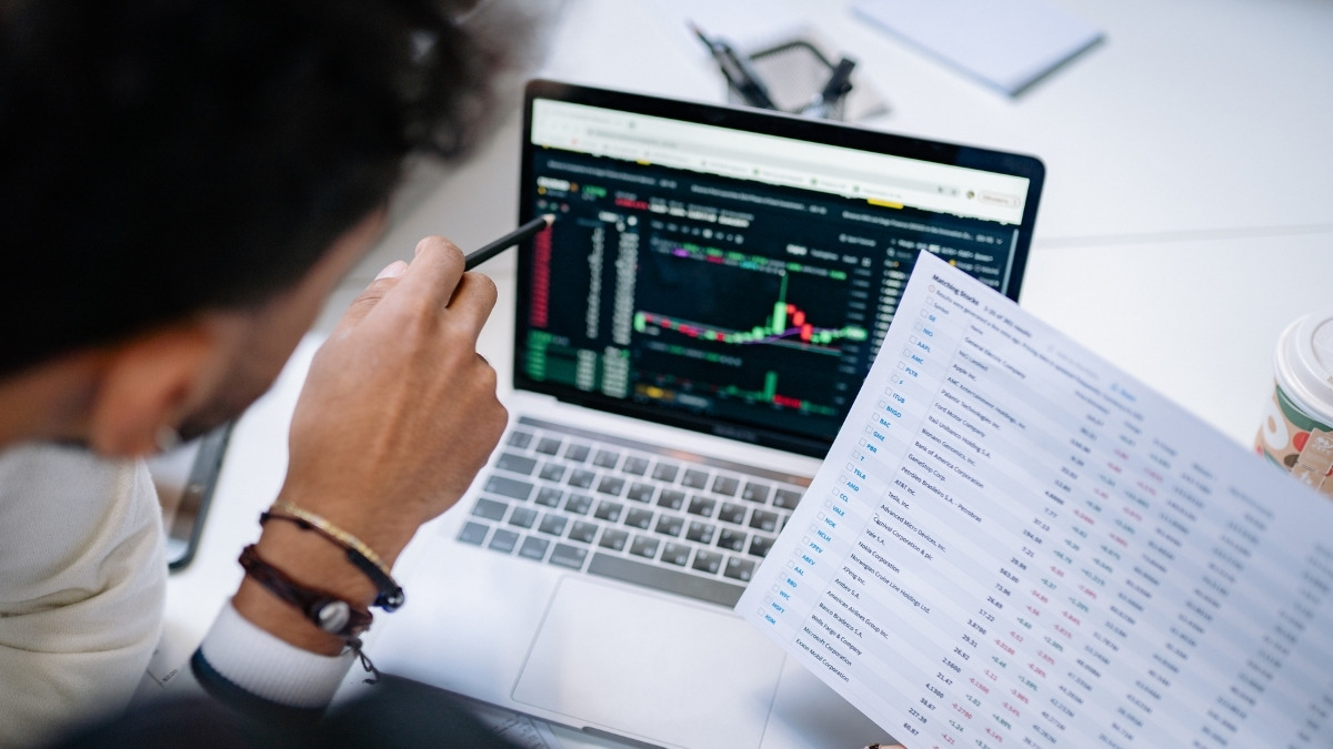 person analyzing stock charts