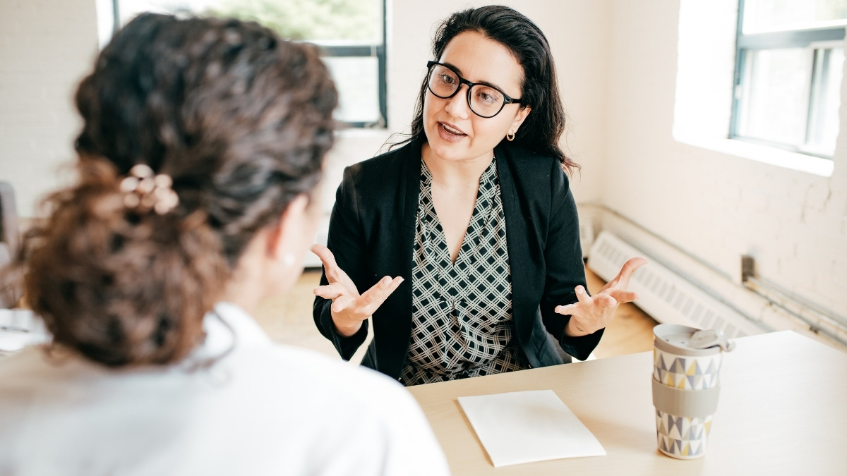 actively speaking and gesturing with both hands